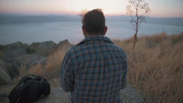 Vista trasera de un hombre y su perro al atardecer — Vídeos de Stock