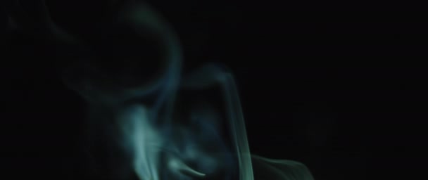Cyan colored incense smoke swirling — Vídeo de Stock