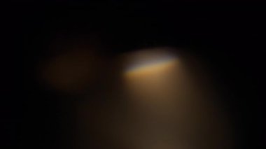 Sıcak ışık sızıntıları ve prizma kırılmaları ağır çekimde üst üste biner.