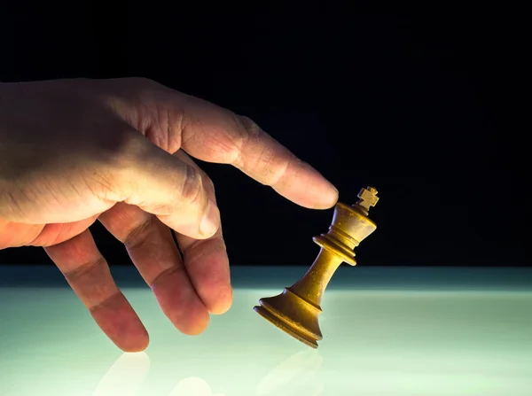 Human Hand Tips a White King Chess Piece — Stock Photo, Image