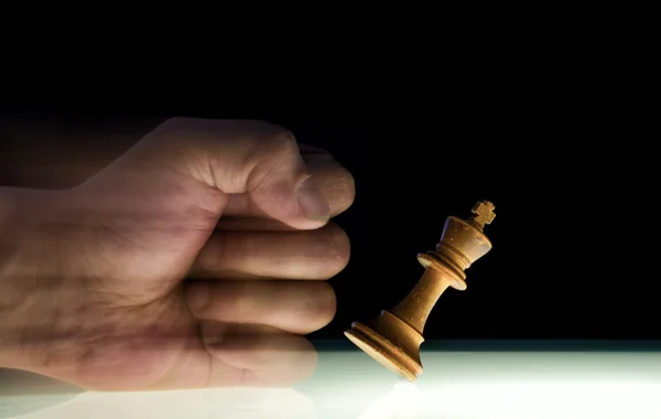 Human Fist Punches over a King Chess Piece — Stock Photo, Image