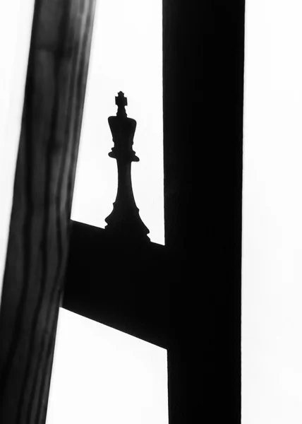 Король шаховий шматок і тінь на стіні — стокове фото