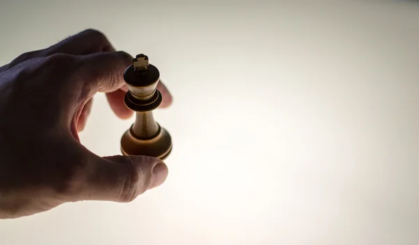 Human Hand Takes a White King Chess Piece — Stock Photo, Image