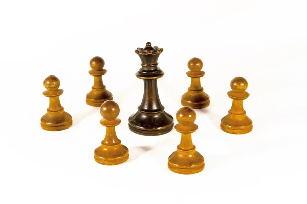 A Black Queen and White Pawns — Stock Photo, Image