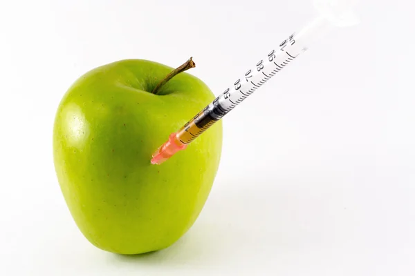 Golden Yellow Apple and Hypodermic Syring — Stock Photo, Image