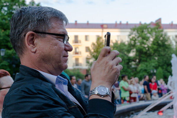 White Man with Glasses and Smartphone