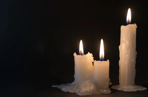 Tři bílé svíčky hořící v noční době — Stock fotografie