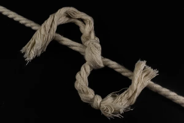 Rope Tied Together in a Frayed Knot Stock Photo