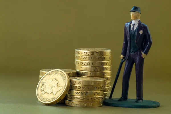 Single Business Man Modelo en miniatura e Inglés Monedas de una libra — Foto de Stock