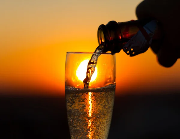 Glasse of white wine on sunset background — Stock Photo, Image