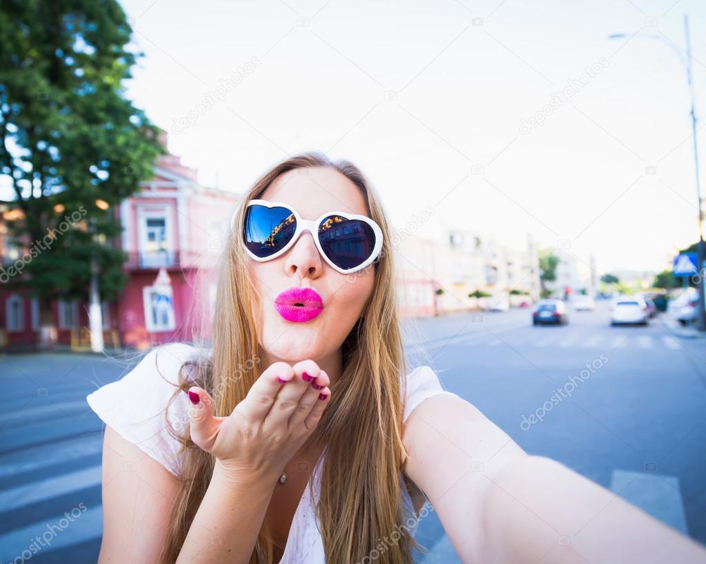Beautiful hipster girl taking selfie