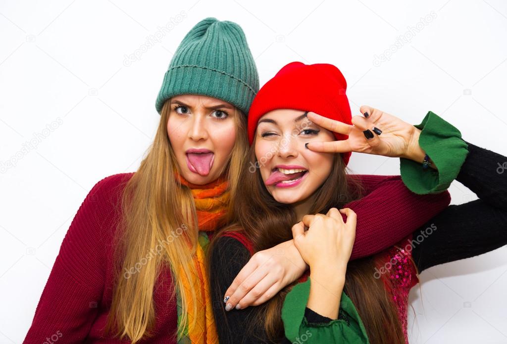 Close up fashion lifestyle portrait of two young pretty women