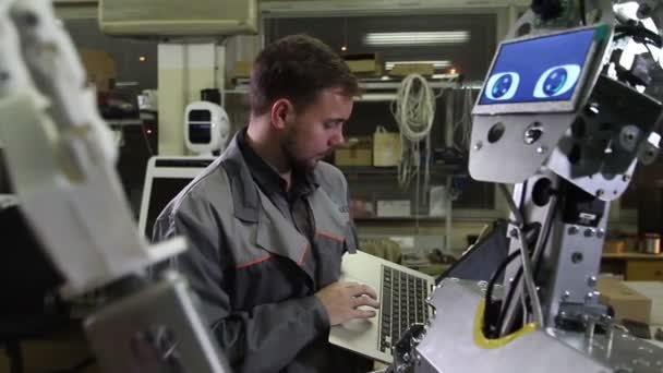 Ingenjör justerar roboten — Stockvideo