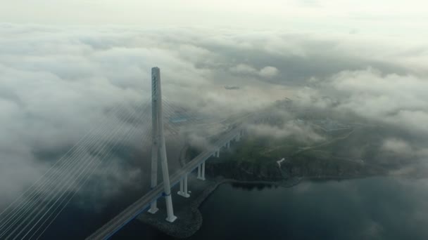 Aerial view of Bridge Russky through the Strait of Eastern Bosphorus abve the clouds — Stock Video