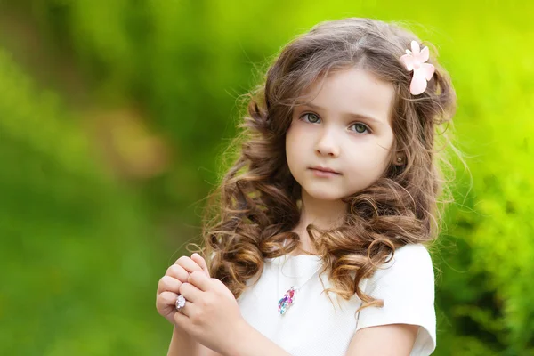 Cute little girl in park Stock Photo by ©photoliko 67618285