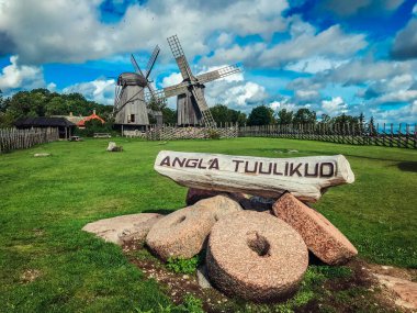 Sarema windmill village. Old wooden windmills in Estonia. Dark windmills. The town of Angla Tuulikud. Tourist attraction in Estonia. clipart