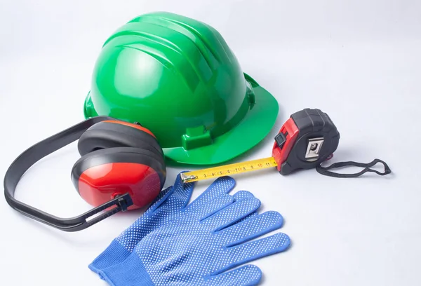 Concept of elements of safety at work such as a helmet, gloves, hearing protection helmets and a meter.