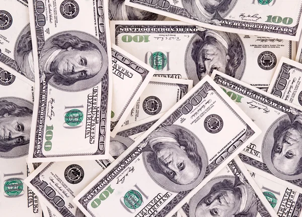 Hundred dollar bills as background. Money pile, financial theme. Stock Photo