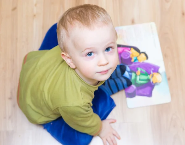 Small boy watching illustrated book — Stock Photo, Image