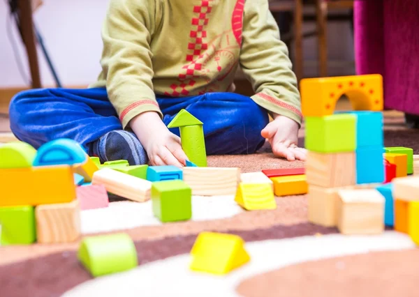 Small child playing with wooden blocks — Stock Photo, Image