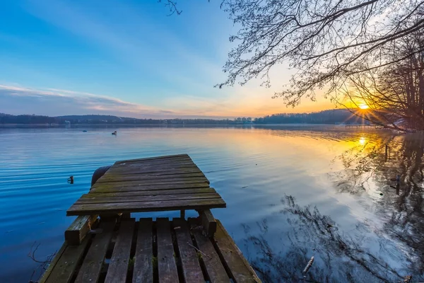Sunrise over lake at end of winter — Stock Photo, Image