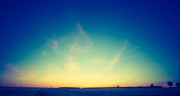 Vintage photo of beautiful sunset over summer field. — Stock Photo, Image