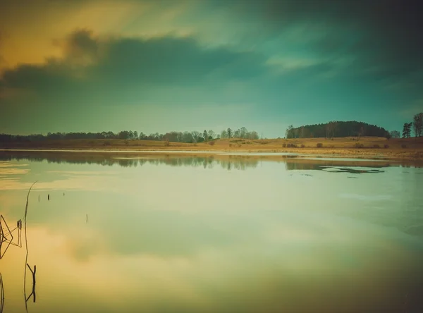 Vintage photo of sunset over calm lake — Stock Photo, Image