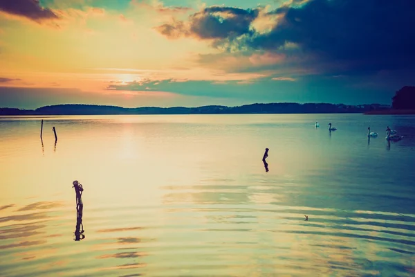 Vintage photo of sunset over calm lake — Stock Photo, Image