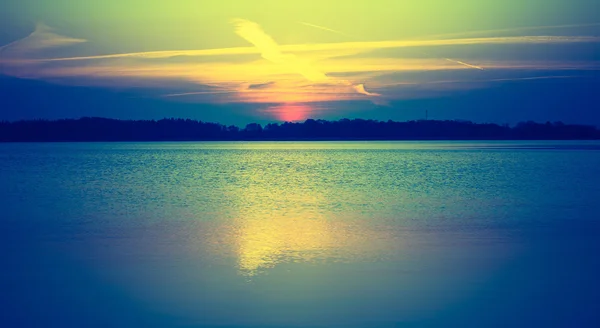 Vintage photo of sunset over calm lake — Stock Photo, Image