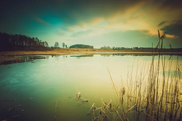 Vintage photo of sunset over calm lake — Stock Photo, Image