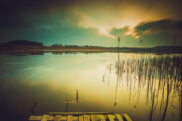 Vintage photo of sunset over calm lake — Stock Photo, Image