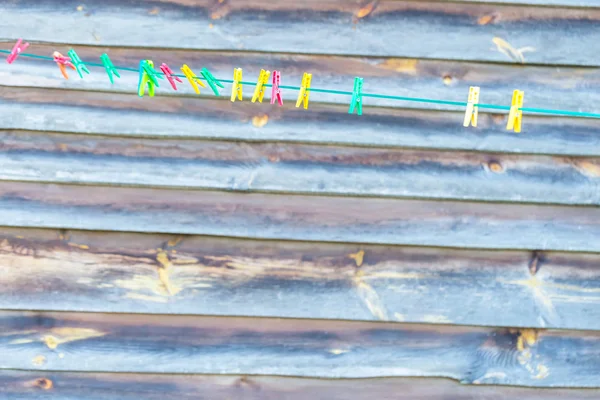 Colorful clips hanging on washing line — Stock Photo, Image