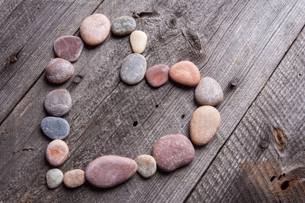 Stone heart on wooden table — Stock Photo, Image