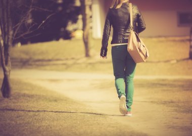 Vintage photo of young girl walking with bag clipart