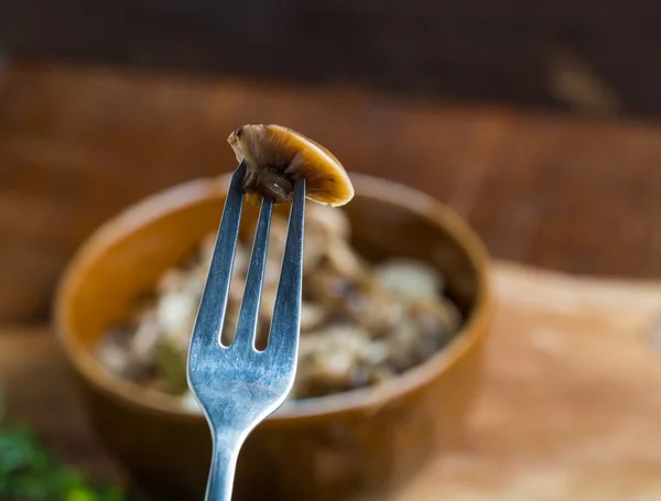 Marinated honey fungus in brown bowl on wooden table. — Stock Photo, Image