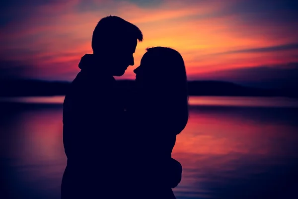 Silhouette di abbracciare coppia contro il cielo del tramonto — Foto Stock