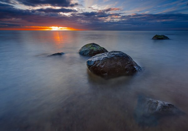 Rocky sea shore at sunrise. Beautiful seascape