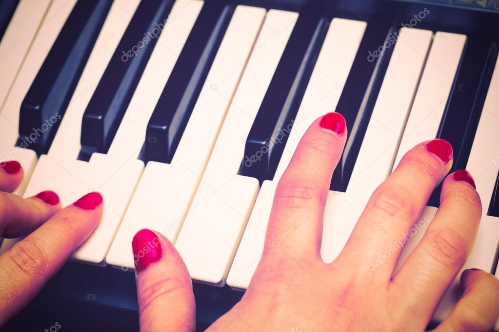 Hands playing on keyboard.