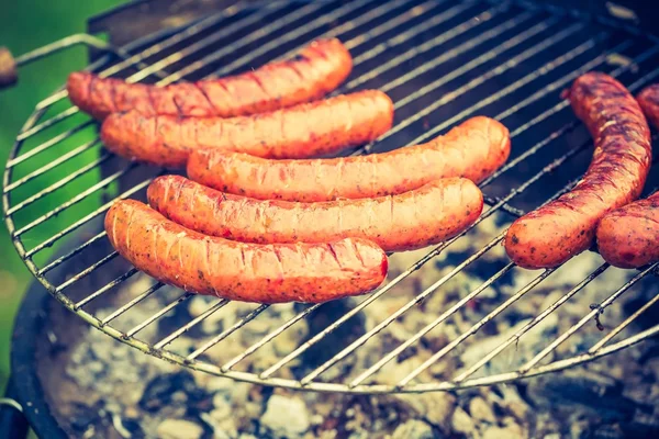 Tasty polish sausage on grill — Stock Photo, Image