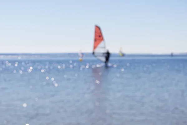 Background of blurry abstraction with windsurfers — Stock Photo, Image