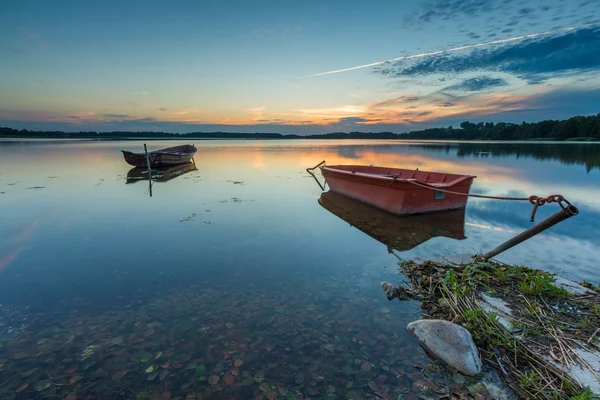 Beautiful lake sunset with fisherman boats — Stock Photo, Image