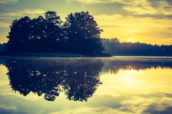 Vintage photo of beautiful sunrise over calm lake. — Stock Photo, Image