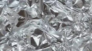 Buruşmuş alüminyum folyo. Parlak doku. Döngü hareketi, soyut arkaplan