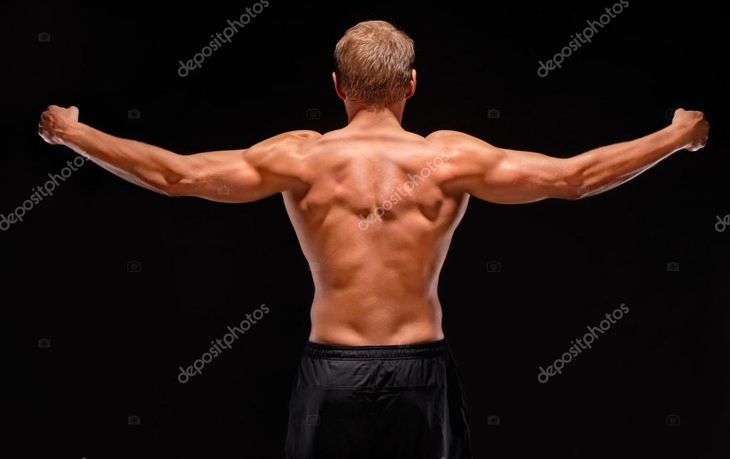 Premium Photo  Rear view of muscular man with his arms stretched out