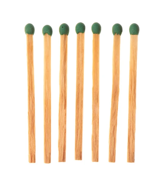 Set of seven green wooden matches isolated on white background — Stock Fotó