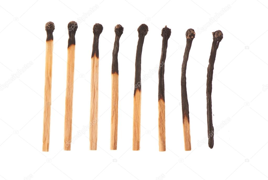 Set of eight burnt wooden matches arranged in ascending order