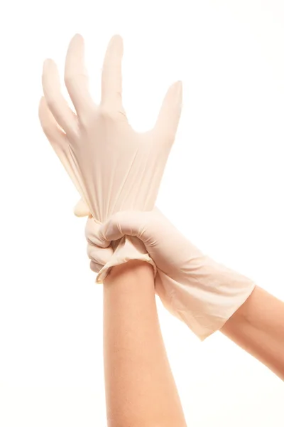 Female doctor's hands putting on white sterilized surgical gloves — Stok fotoğraf