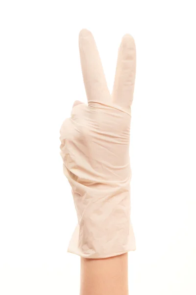 Main du médecin en gant chirurgical stérilisé blanc montrant un signe de victoire — Photo