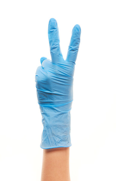 Female doctor's hand in blue surgical glove showing victory sign