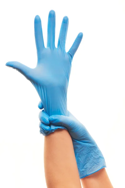 Female doctor's hands putting on blue sterilized surgical gloves — Stock Photo, Image